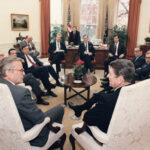 Then-Associate White House Counsel Chris Cox meets in the Oval Office with President Reagan, Vice President Bush, Fed Chairman Alan Greenspan, Treasury Secretary Nick Brady, and other administration officals to discuss the causes of the October 19, 1987 stock market crash.